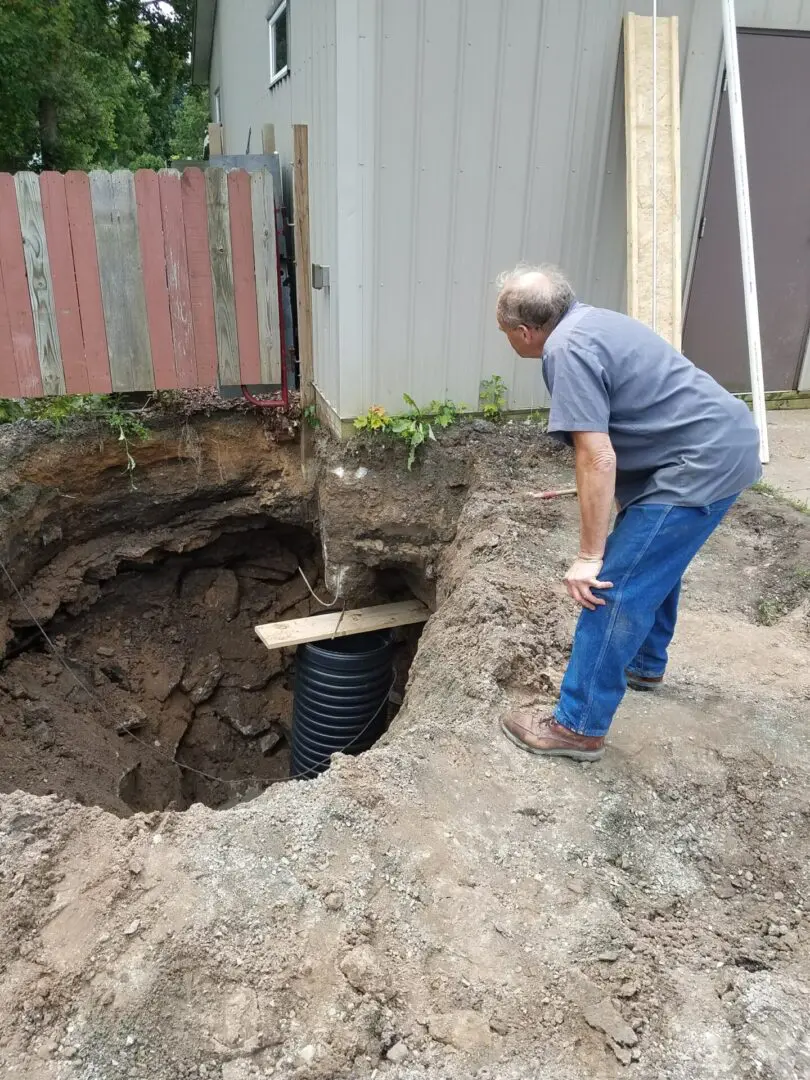A person looking at a septic tank