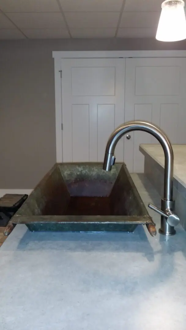 A concrete sink with a faucet