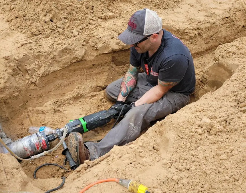 Plumber working at outdoor site